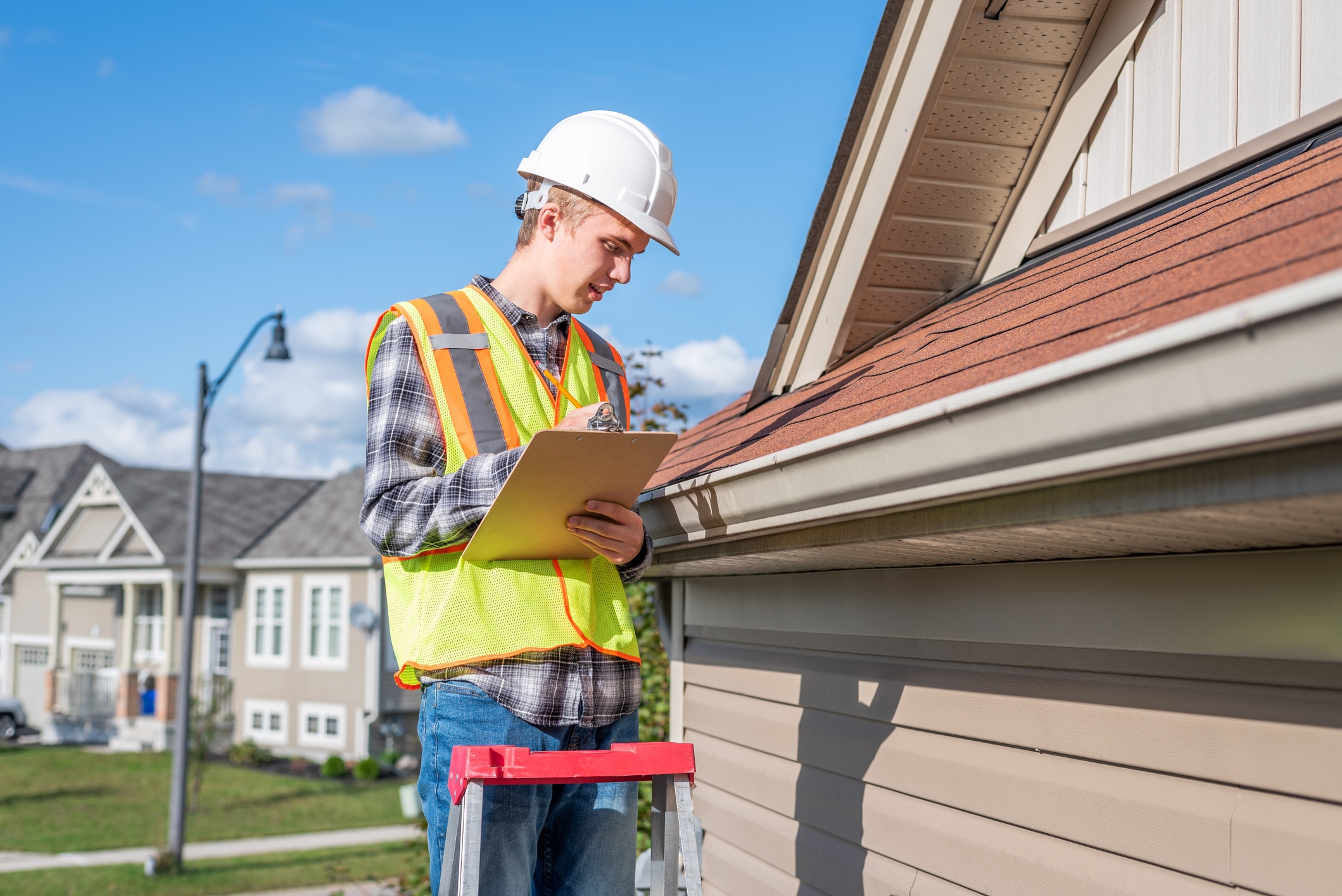 A roofing contractor inspects a roof in Baltimore County, Maryland. Routine inspections can tell you if you need a roof replacement.